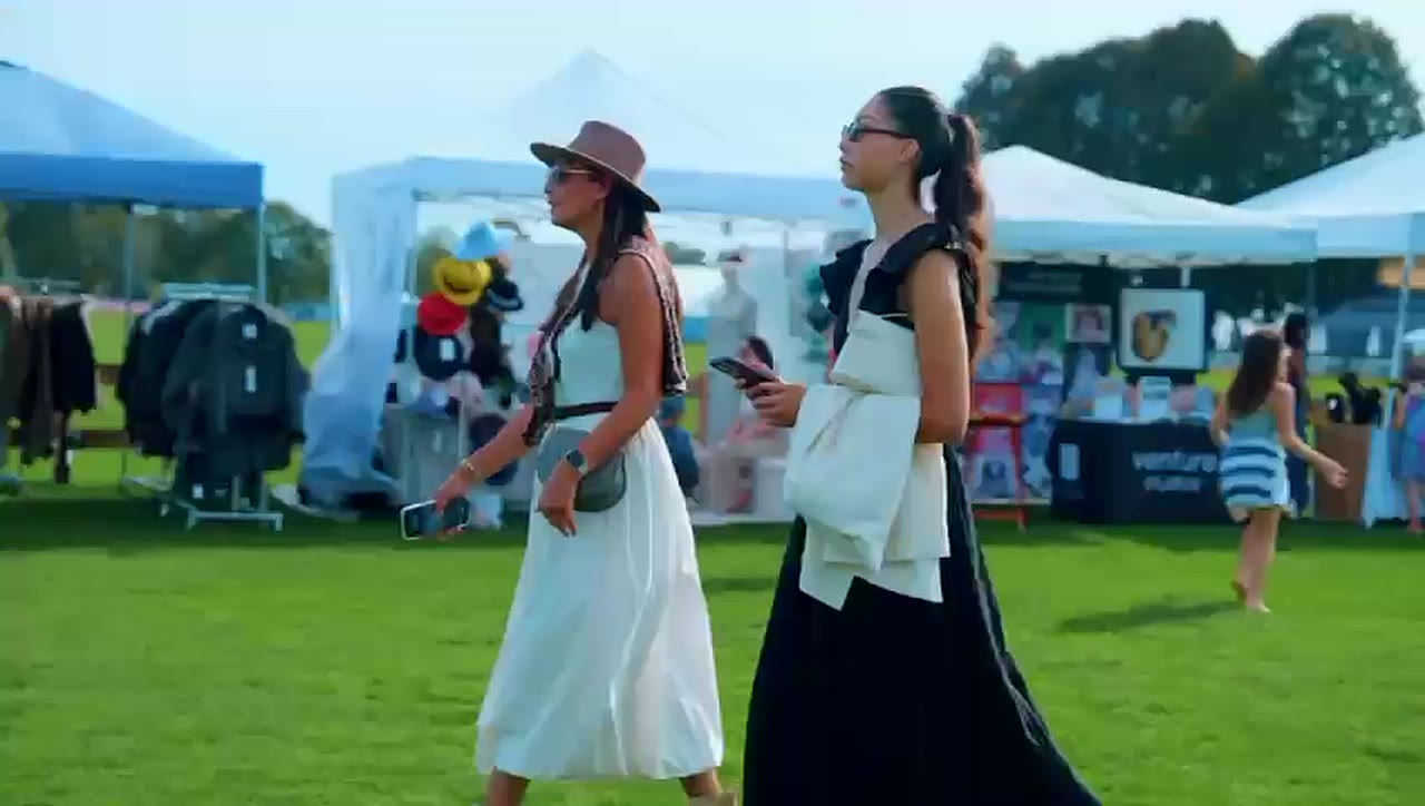 Guests walking past the vendor tents, 2025