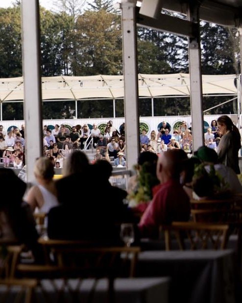 Guests at ringside tables in the hospitality tent overlooking Trelawny Stadium