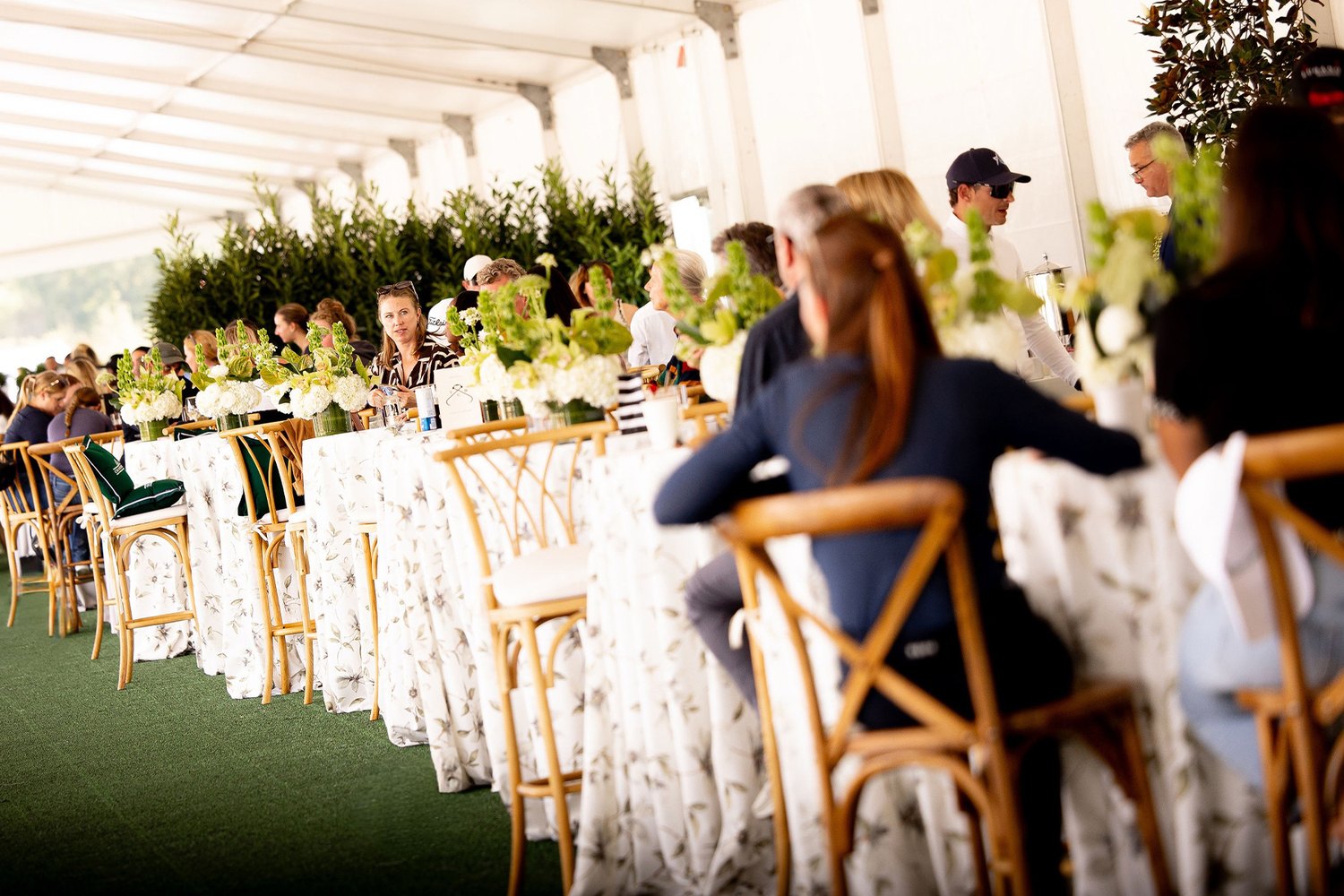 Guests at flower-dressed tables in the hospitality tent