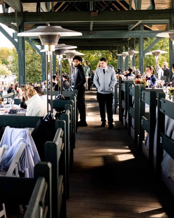 Guests dining on the covered terrace above the ring